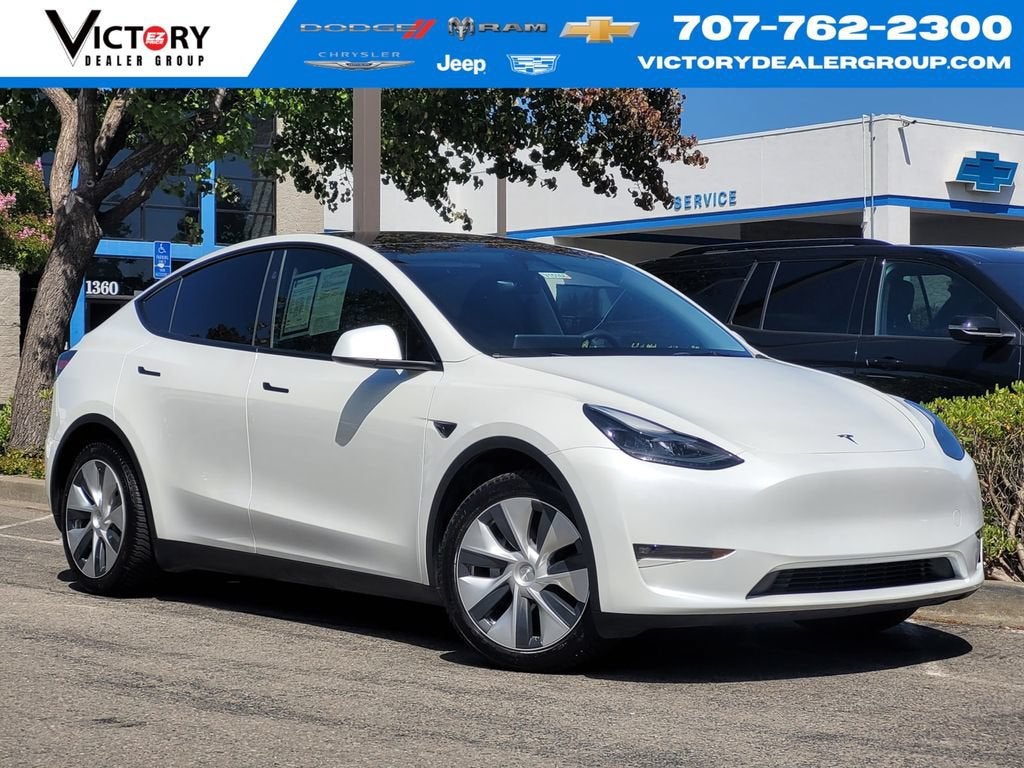 2024 Tesla Model Y Long Range in White — front three-quarter view
